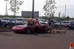 [PICS] Man Struggles to a Fit Giant Stuffed Bear in his C5 Corvette Convertible