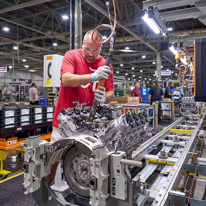 Worker at GM's Flint Engine Operations secures high pressure fuel line on all-new Gen-6 V8.